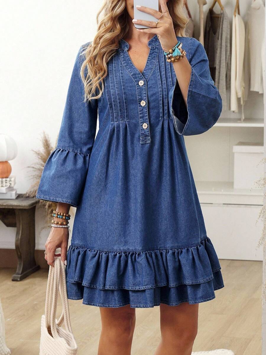 Full front view of medium-blue button-front denim mini dress with flared cuffs and ruffle tiers