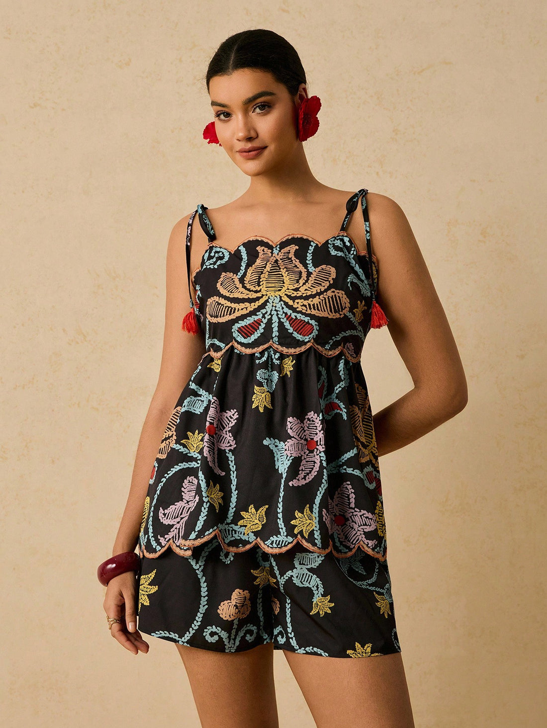 Elevate your seasonal wardrobe with this fabulous two-piece set designed for confident curves! The asymmetric ruffle camisole adds a flirty, fashion-forward touch, while the coordinating shorts offer comfort and style. Perfect for warm weather adventures, casual outings, or relaxed evenings at home. This playful pairing celebrates your unique style with modern flair and effortless charm. Mix, match, or wear together—either way, you'll feel amazing!