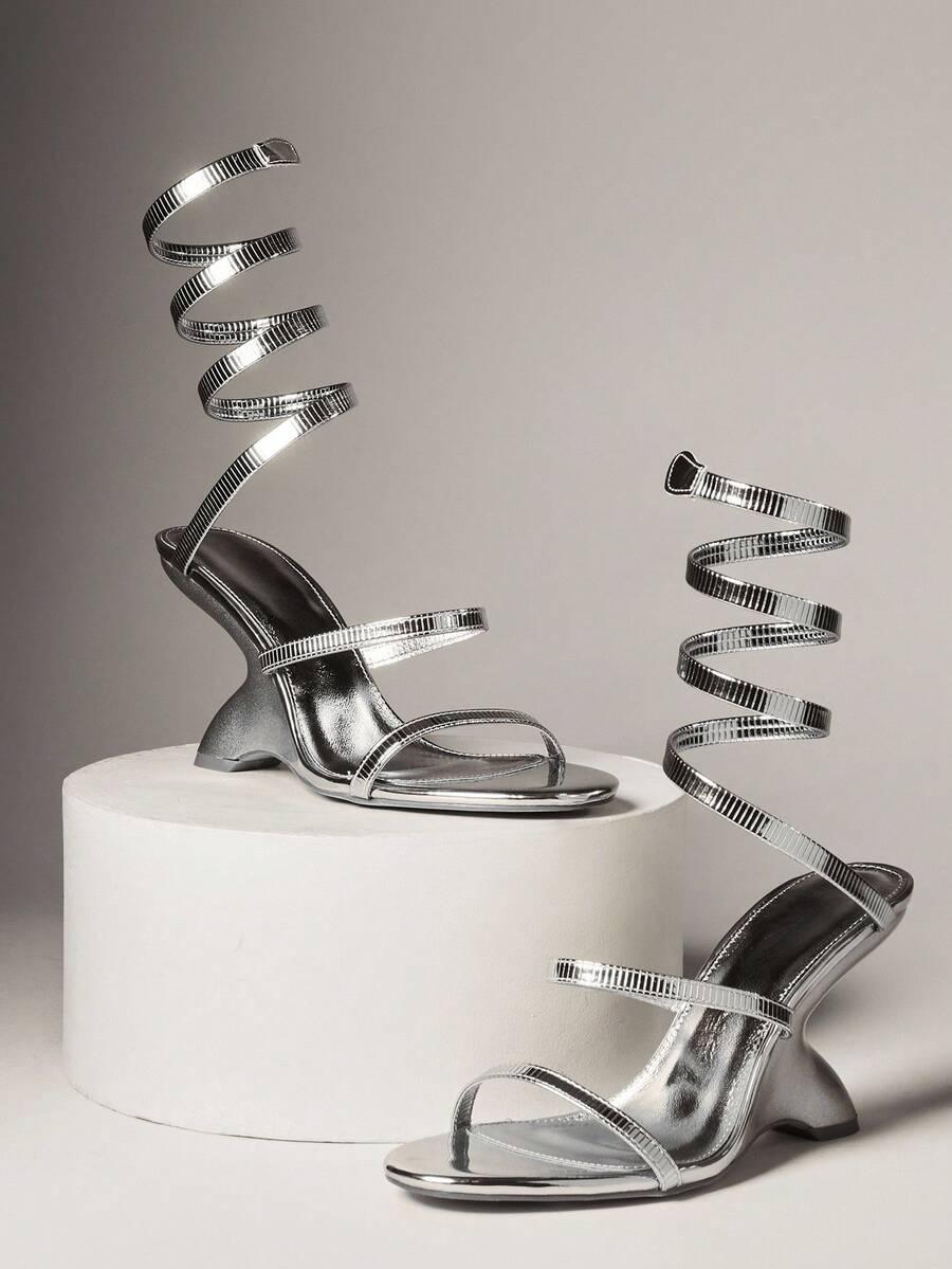 Step into the spotlight with these show-stopping chrome high-heeled sandals that blend modern glamour with festive flair. The eye-catching gemstone cross straps add a touch of sparkle and sophistication, making them the perfect companion for holiday celebrations and special occasions. Crafted for those who dare to shine, these sandals deliver both style and confidence with every stride. Whether you're dancing the night away at a Christmas party or making a grand entrance, these beauties promise to turn head