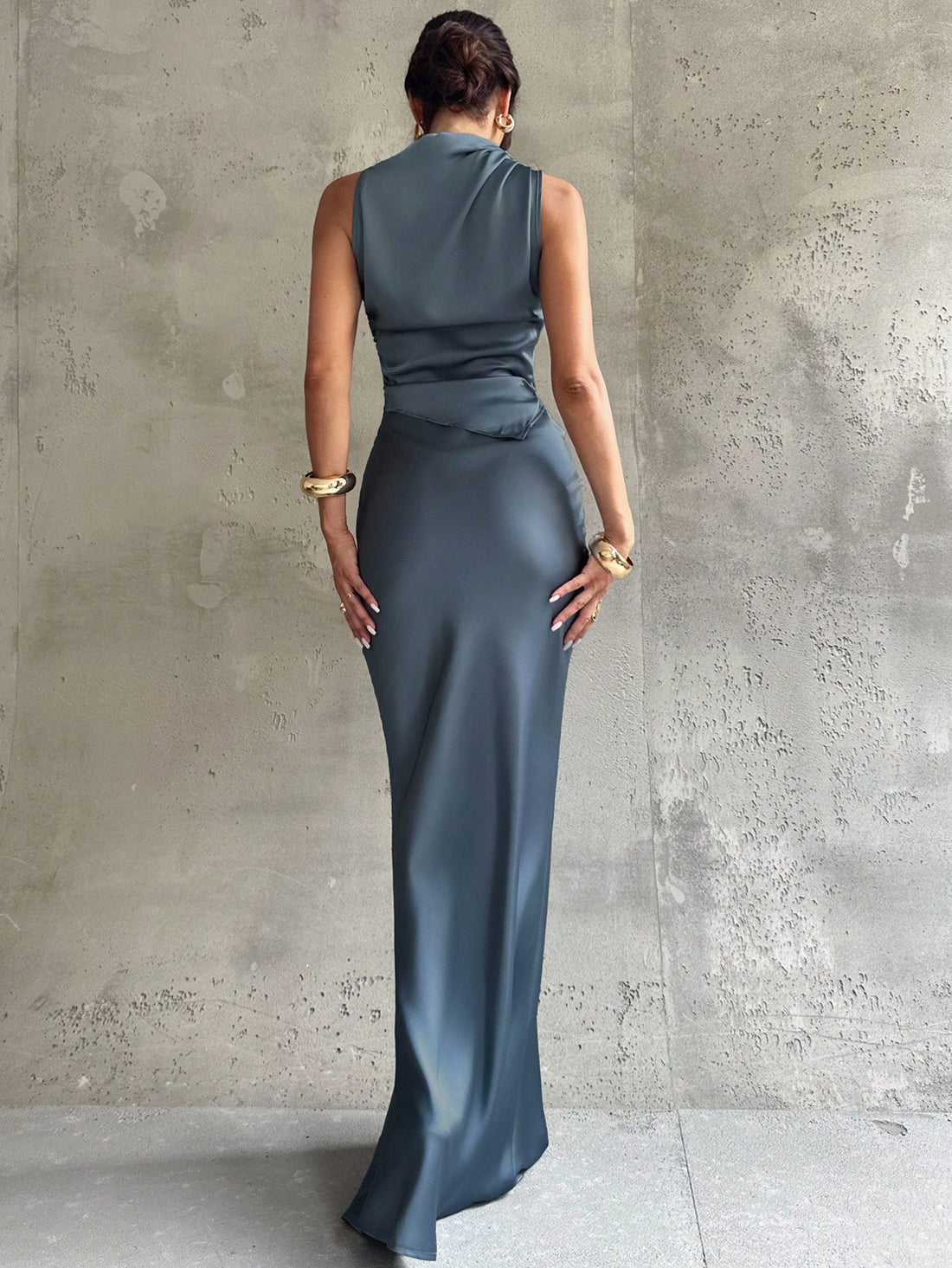 Elevate your workweek wardrobe with this chic two-piece set that effortlessly transitions from boardroom to brunch. The sleeveless shirt features a crisp pleated collar that adds instant polish, while the high-low midi skirt brings modern flair with its asymmetrical hem. Crafted in luxurious blue satin, this pairing delivers that "I woke up like this" sophistication—because looking put-together shouldn't feel like work. Perfect for professionals who refuse to compromise on style.