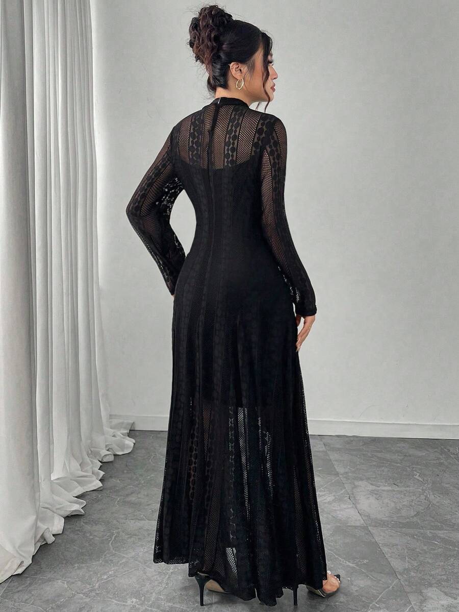 Model wears black sheer lace maxi dress with high neck and long sleeves