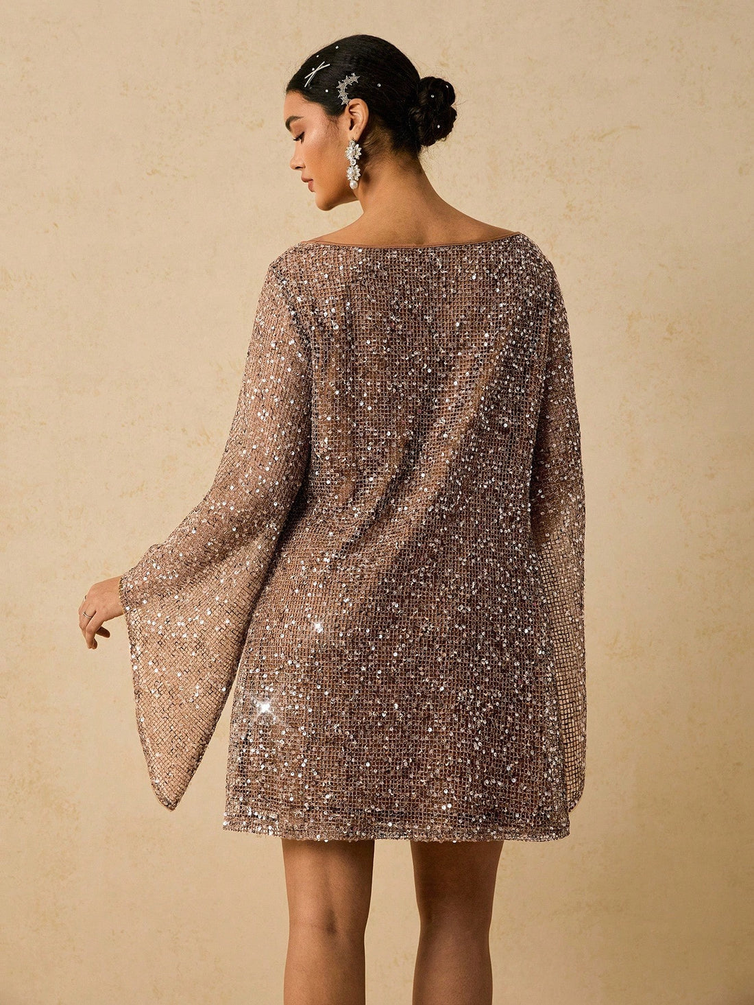 Shine bright through the season in this show-stopping sequin flare sleeve dress! Designed for curves and confidence, this versatile piece transitions seamlessly from autumn gatherings to holiday parties. The shimmering sequin details catch the light beautifully, while flared sleeves add a touch of dramatic flair. Whether you're celebrating Halloween, ringing in the New Year, or attending a Christmas bash, this dress delivers instant glamour and comfort. Perfect for anyone who loves to make a statement and c