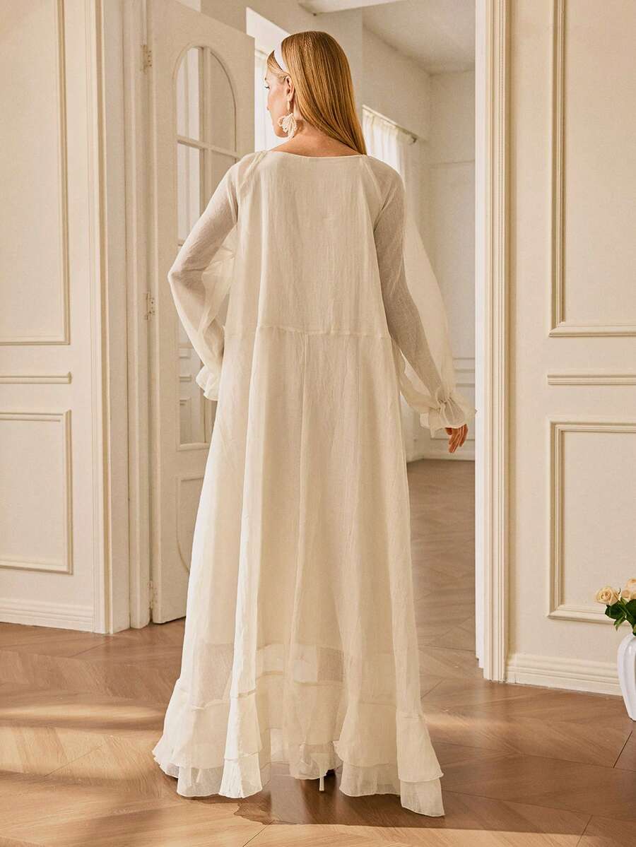 Effortlessly transition from summer vibes to autumn adventures in this stunning sheer ruffle trim long sleeve dress. The delicate ruffled edges add a touch of romantic flair, while the flowing silhouette keeps you cool and comfortable. Whether you're strolling along the beach or embracing cozy fall days, this versatile piece layers beautifully and works as a cover-up or standalone statement. Dress it up with heels for evening elegance or keep it casual with sandals for laid-back charm. A wardrobe essential 