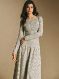 Close front view of the striped maxi dress showing round neckline, button placket, and long sleeves