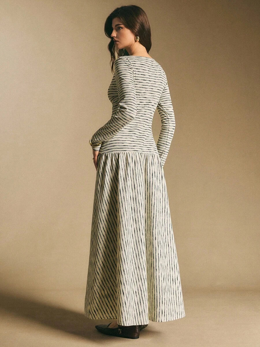 Front view of a cream and black horizontally striped long-sleeve maxi dress with fitted bodice, button placket, and full skirt