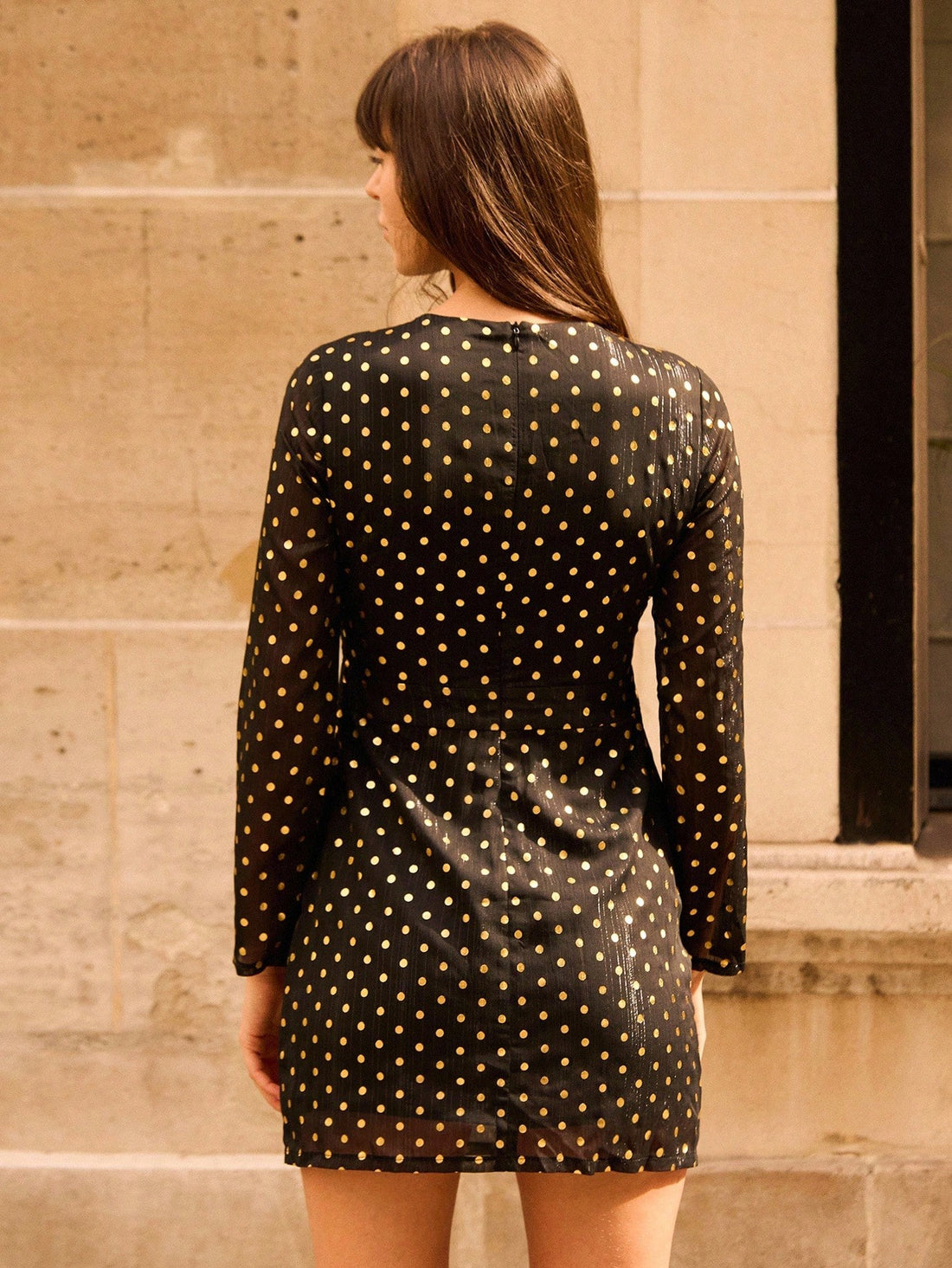 Make a statement this fall with our eye-catching black mini dress featuring shimmering metallic polka dots that catch the light beautifully. The sophisticated twist neck detail adds an unexpected touch of elegance, while the playful foil print keeps things fun and flirty. Perfect for fall parties, date nights, or anywhere you want to turn heads. This dress effortlessly transitions from casual to dressed-up, giving you versatile style that works as hard as you do. Slip it on and let your confidence shine as 