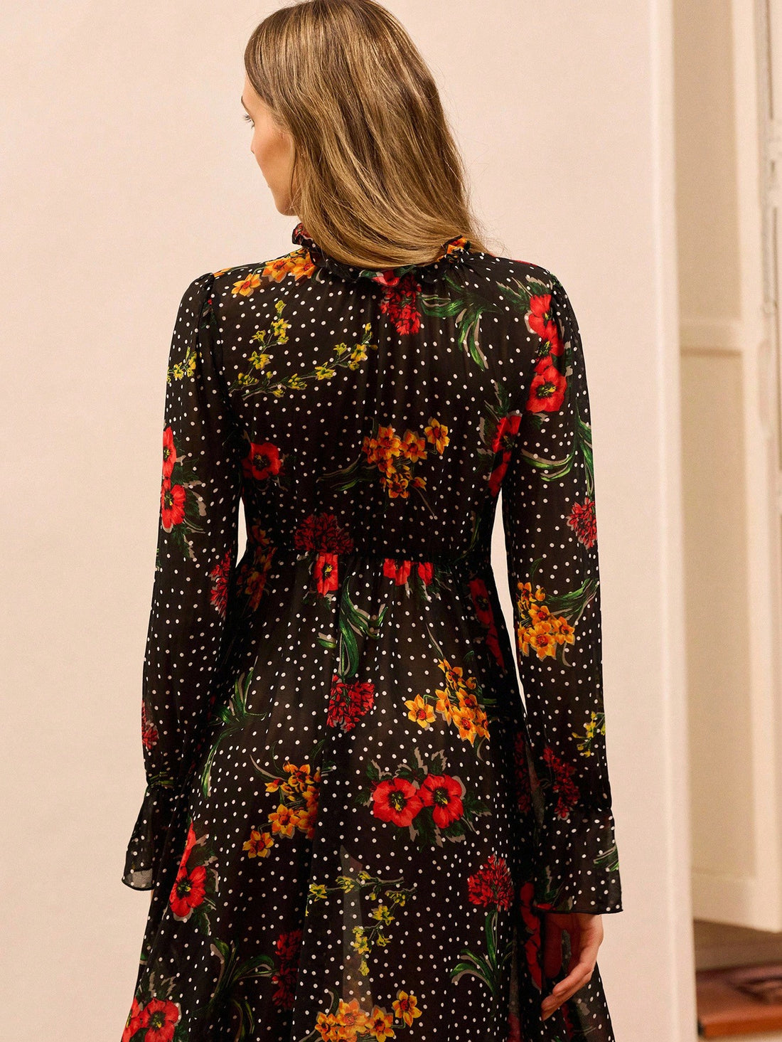 Make a statement this autumn with our stunning black floral maxi dress—where sophistication meets fun! The high neckline keeps things polished for the office, while the asymmetric ruffle hem adds a playful twist that transitions seamlessly from boardroom to brunch. Crafted for those who refuse to choose between elegance and personality, this versatile piece layers beautifully over turtlenecks or stands alone as your go-to dress for any occasion. Effortlessly chic, endlessly wearable.