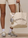 Cream canvas sport tote bag with taupe musera sport logo and beige shoulder straps