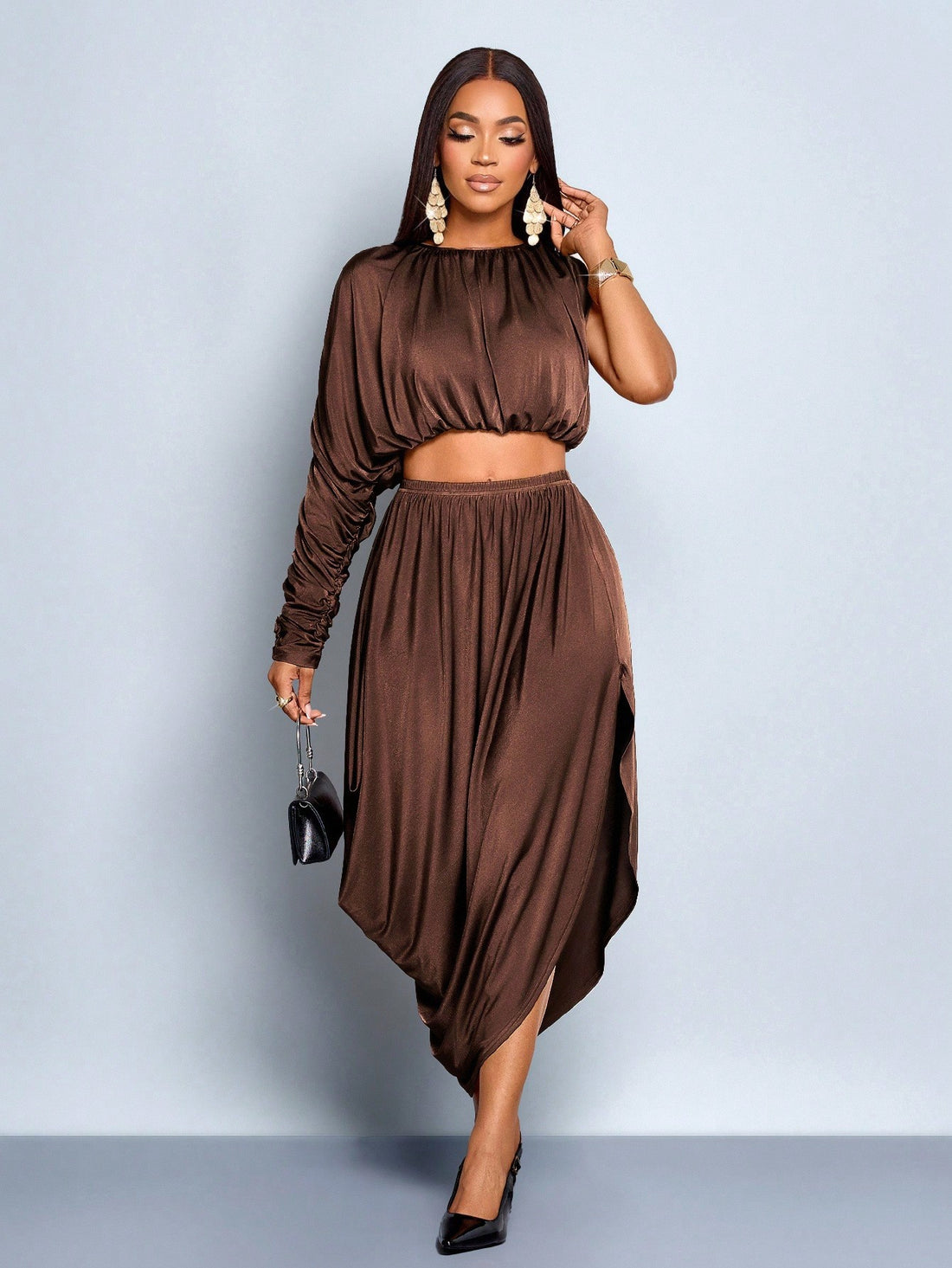 Elevate your cold-weather wardrobe with this stunning two-piece set that's equal parts sophisticated and fun. Crafted from luxurious glossy knit fabric, the asymmetrical sleeves add an unexpected twist that catches the eye and flatters your silhouette. Perfect for layering through autumn and winter, this set transitions effortlessly from cozy nights in to stylish outings. The rich texture and modern design details make it a versatile staple that pairs beautifully with your favorite accessories. Embrace the 