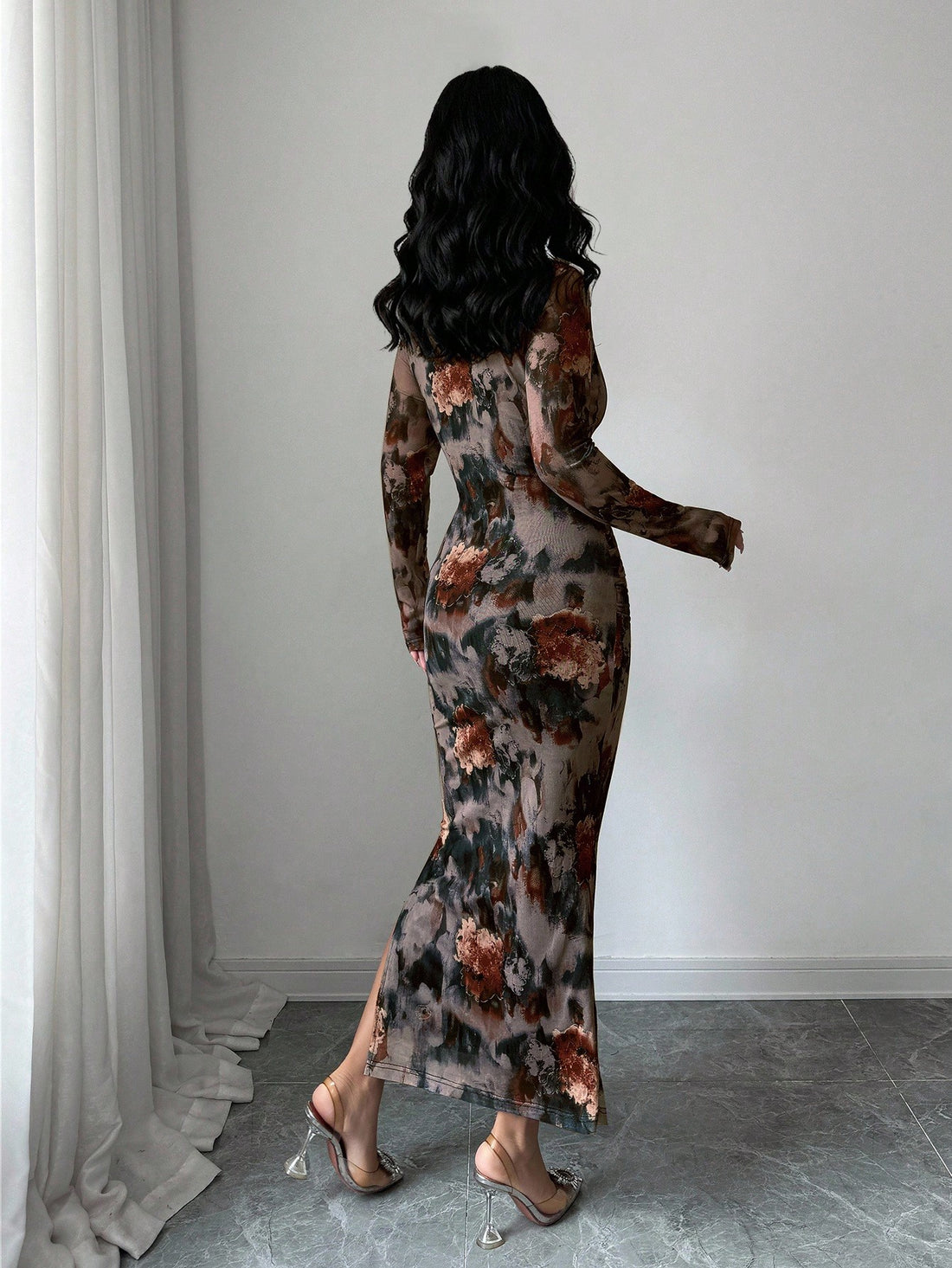 Slip into sophistication with this stunning gray floral maxi dress that effortlessly transitions from evening events to special occasions. The luxe silhouette features elegant long sleeves and a daring high slit that adds just the right amount of drama and movement. Crafted for the modern woman who refuses to compromise on style, this dress combines timeless florals with contemporary flair. Whether you're heading to a gala, wedding, or night out, you'll turn heads in this show-stopping piece that proves ele