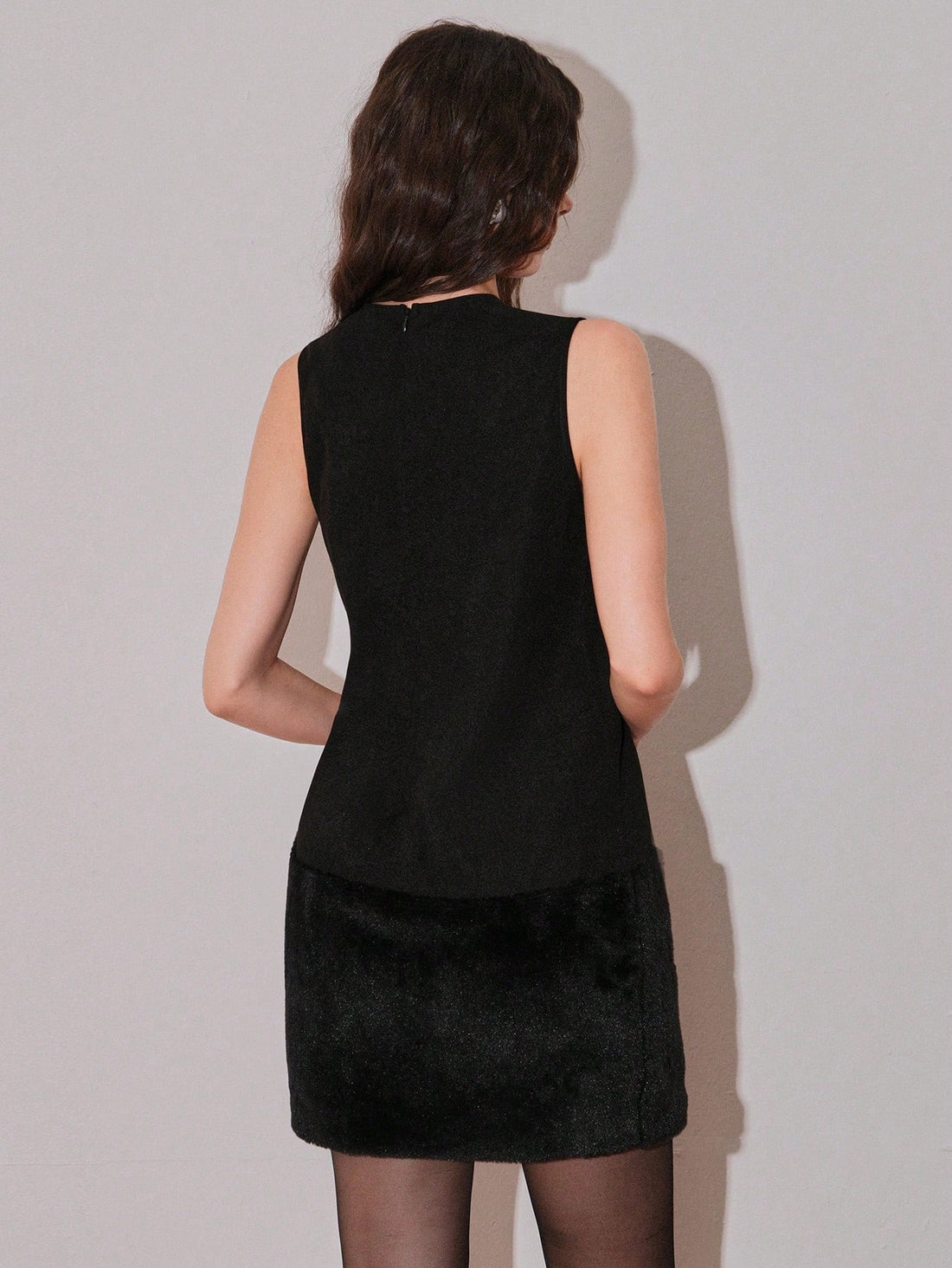 Make a bold fashion statement with this sleek sleeveless mini dress featuring a playful furry hem that adds instant texture and flair. The timeless round neckline and solid color palette keep things effortlessly chic, while the mini silhouette ensures you'll turn heads wherever you go. Perfect for nights out, parties, or whenever you want to feel confident and fabulous. This dress pairs beautifully with heels, sneakers, or boots—let your style shine!