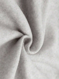 Close-up of light heather-gray sweatshirt fabric showing soft heathered surface and folds