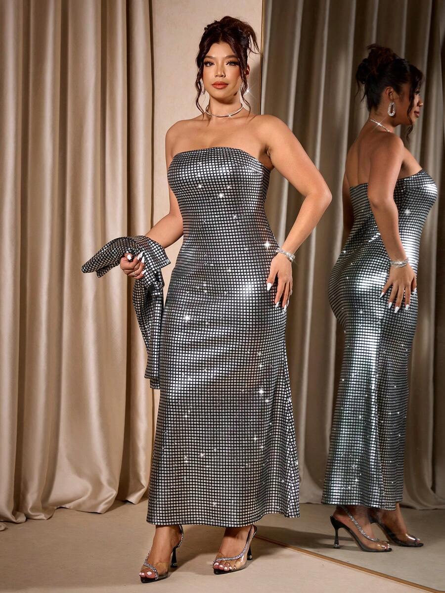 Celebrate the season in style with this stunning plus-size Christmas set. The silver foil bandeau bodycon dress features a sleek, form-fitting silhouette that shimmers with festive sparkle, while the coordinating cardigan adds versatility and warmth for holiday parties, dinners, or special events. Perfect for creating a glamorous, polished look that transitions seamlessly from day to night. Embrace your curves with confidence in this eye-catching two-piece ensemble designed to make you feel fabulous.