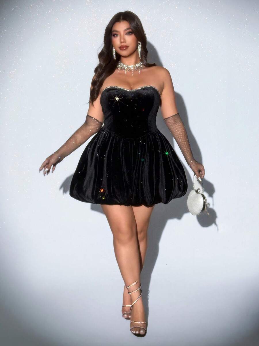 Back view of black mini dress with fitted bodice, zipper closure, and flared hem