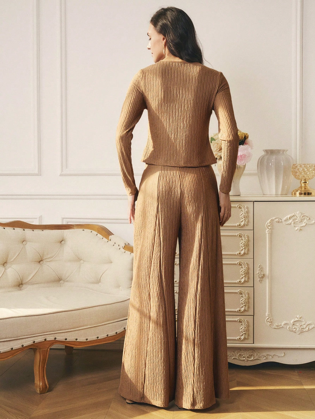 Get ready to slay in this stylish 2-piece knit set! The button-detail top adds a touch of charm while the long leg pants keep you cozy and chic. Perfect for a day out or a night in, this set will have you feeling confident and comfortable. Don't forget to strike a pose!