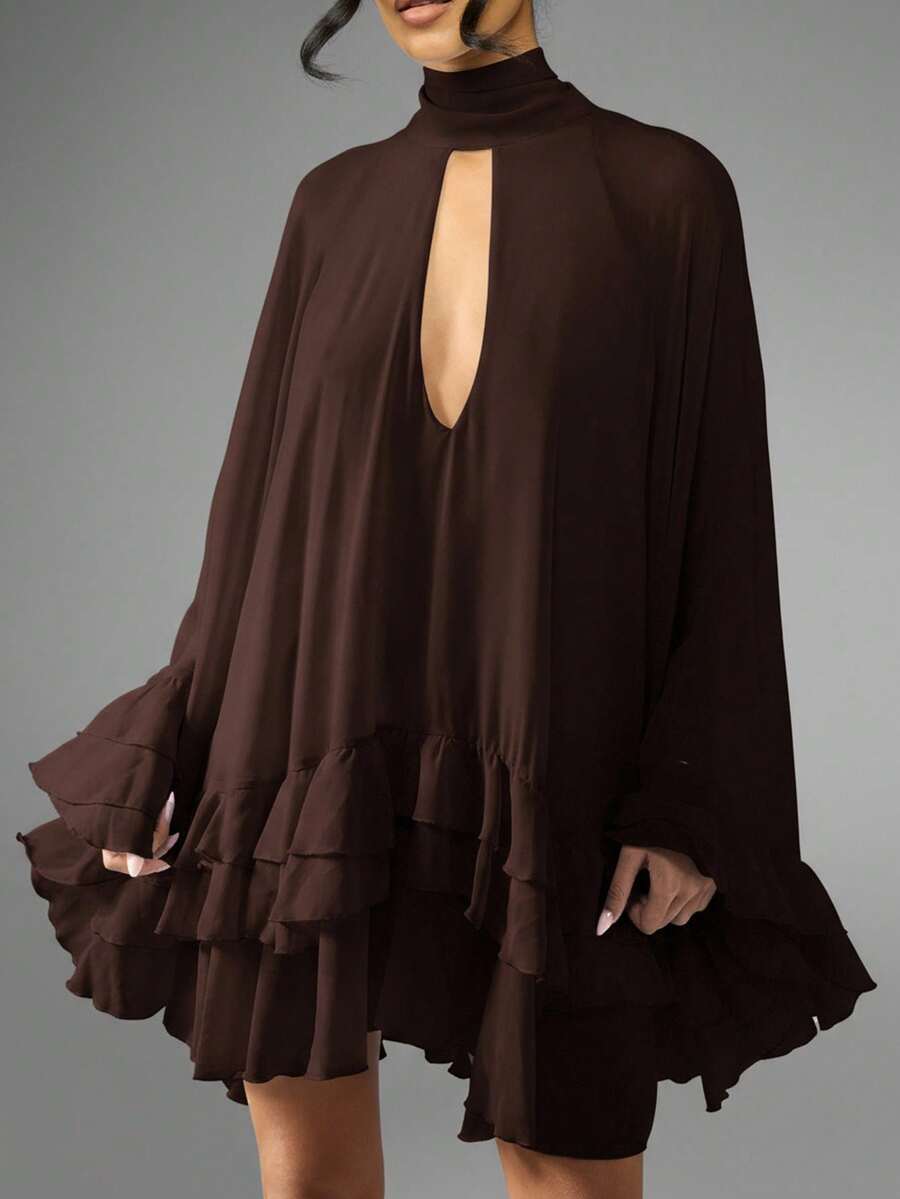 Turn heads effortlessly in this chiffon cape mini dress, designed with a playful high neck keyhole and charming tiered ruffle hem. Its light, flowing fabric adds movement and grace, perfect for making every special occasion feel unforgettable. Embrace a mix of elegance and fun with this standout piece that’s as spirited as you are.