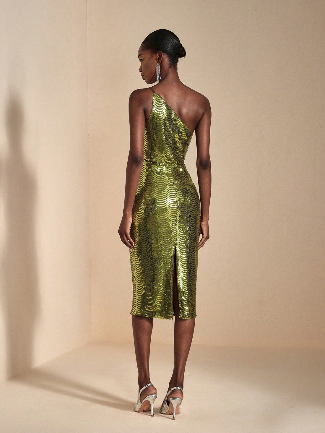 Turn heads at your next event in this show-stopping asymmetric sequin bodycon midi dress! Crafted with shimmering sequins that catch the light from every angle, this dress features a flattering bodycon silhouette and a cheeky side slit for movement and sass. The asymmetric neckline adds modern edge to classic elegance, making it perfect for cocktail parties, date nights, or anywhere you want to feel absolutely fabulous. Slip it on and let your confidence do the talking!