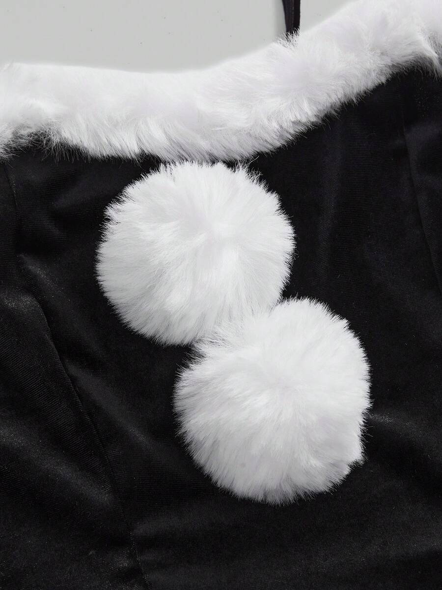 Close-up of white faux fur neckline trim and pom-pom accents on black dress