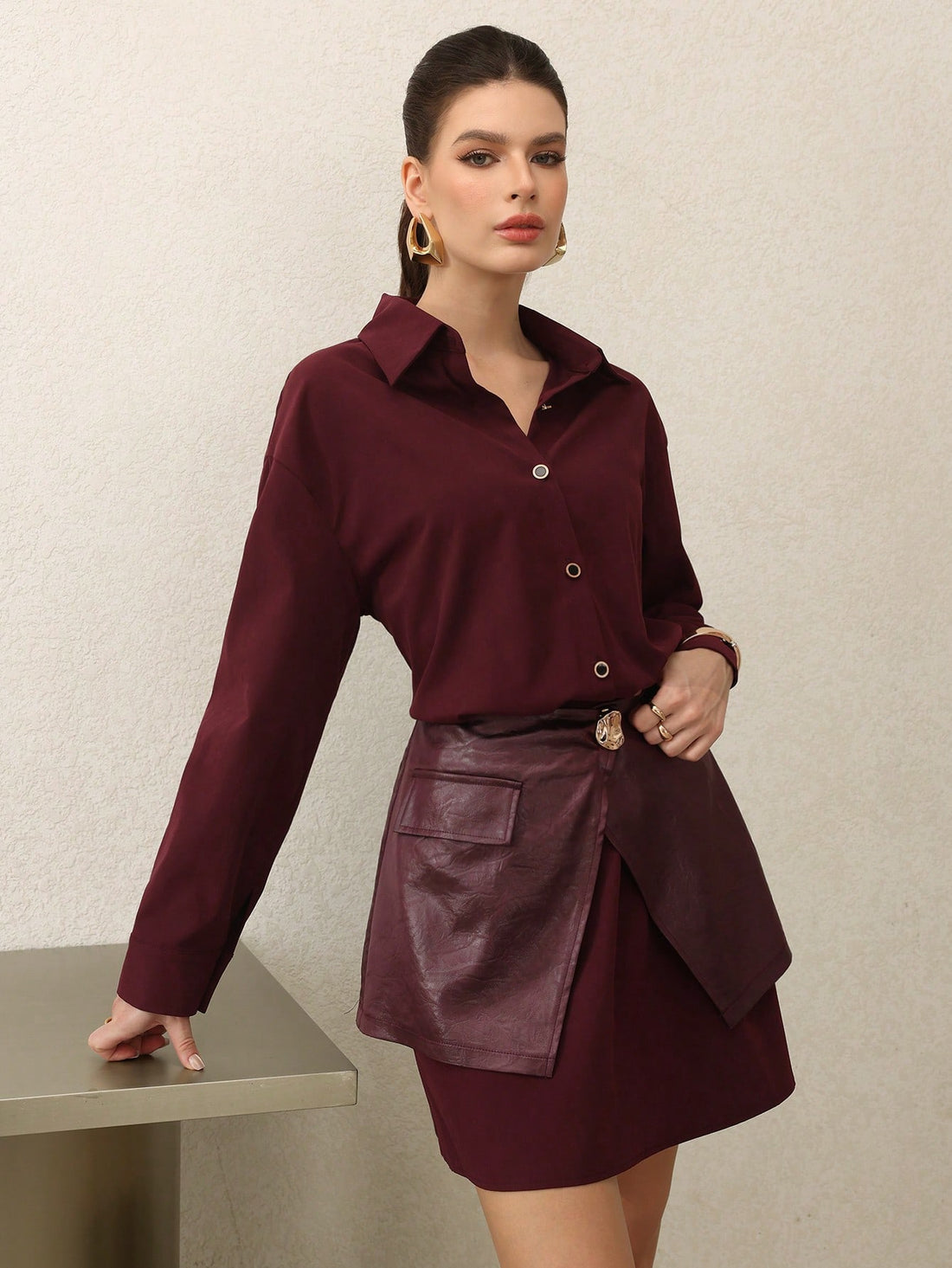 Elevate your seasonal wardrobe with this stunning 2-piece shirt dress in rich Encore red. The clever waist tie detail cinches your silhouette while the coordinating pieces layer effortlessly for versatile styling. Whether you're dressing up for brunch or keeping it casual, this chic ensemble transitions seamlessly from autumn into winter. The sophisticated color and thoughtful construction make it a go-to piece that works as hard as you do. Dress it up with heels or down with sneakers—this is the kind of wa