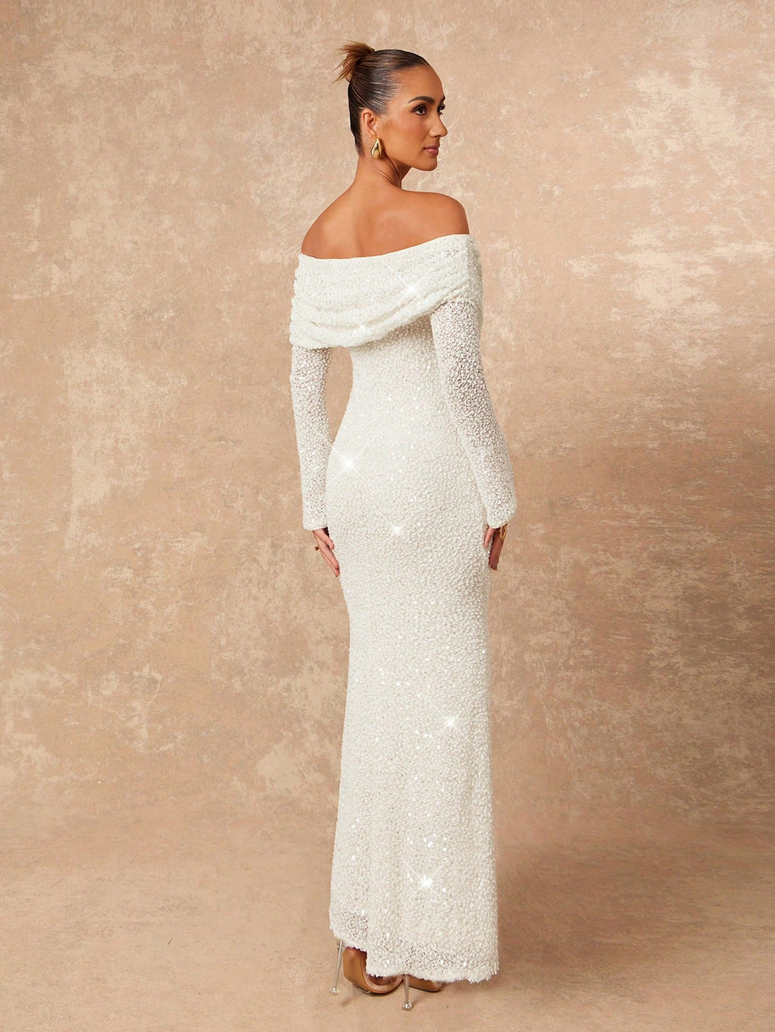 Turn heads at your next soirée in this show-stopping off-shoulder bodycon dress. The playful ruffle hem adds movement and dimension, while the fitted silhouette flatters every curve. Perfect for fall and winter galas, holiday parties, or any occasion calling for elegance with a touch of sass. Slip into luxury and let your confidence do the talking.