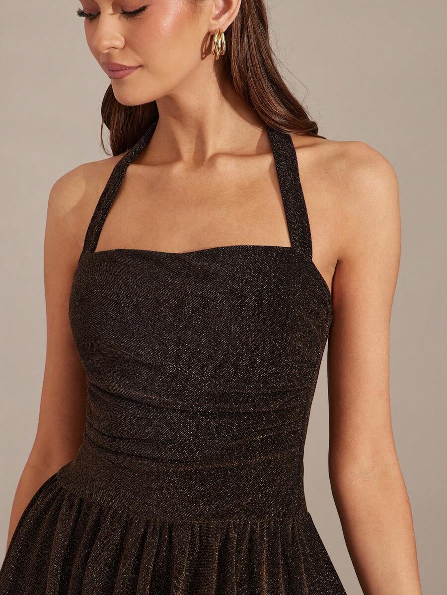 View 1 of glitter halter bubble skirt mini dress with square neckline, backless tie neck, ruched waist, and sparkle fabric