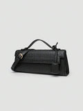 Ostrich embossed structured top handle shoulder bag with flap closure and adjustable strap