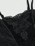 Close-up of black velvet camisole with floral lace applique and spaghetti straps
