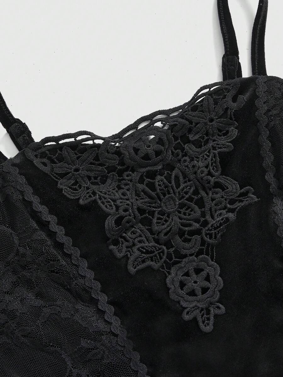 Close-up of black velvet camisole with floral lace applique and spaghetti straps