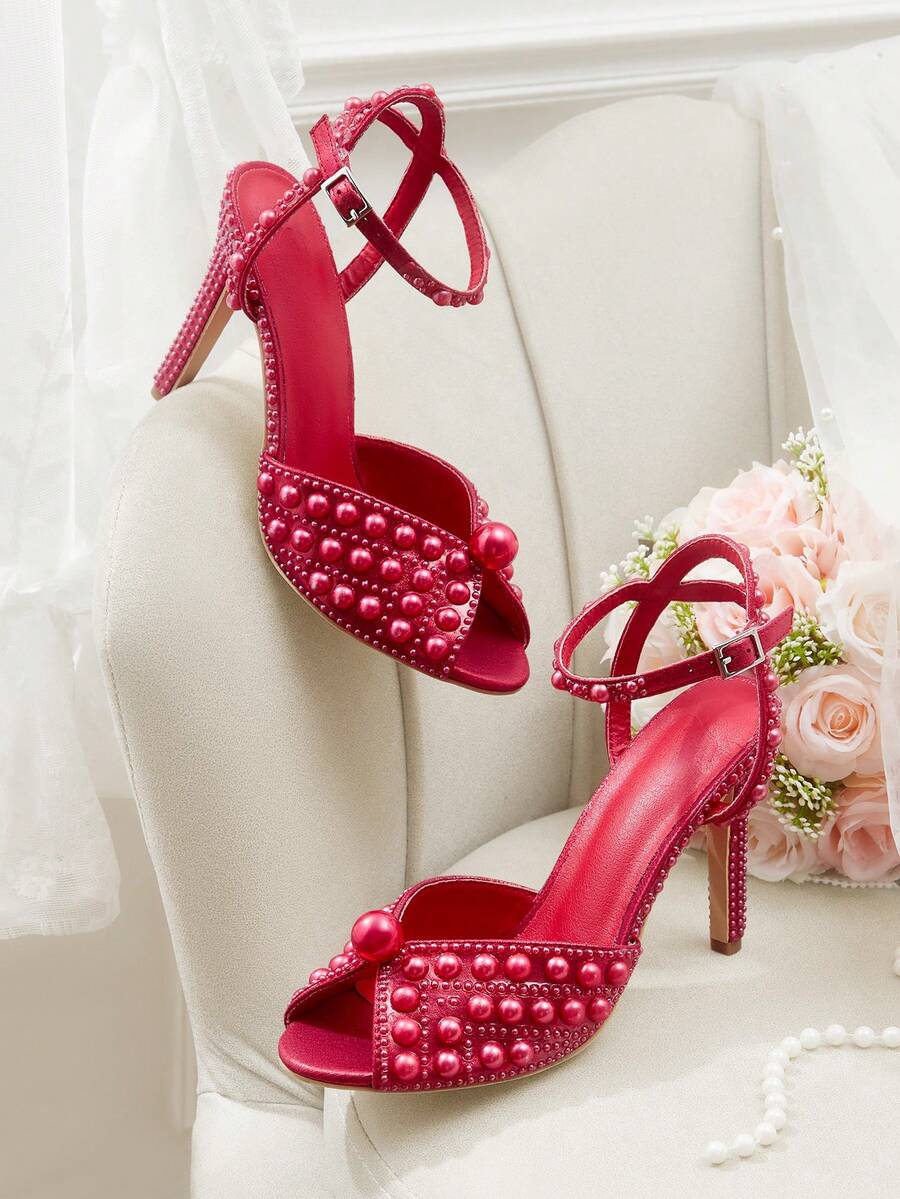 Step into sophistication with these stunning pearl-adorned peep-toe stiletto sandals! Designed for the woman who refuses to compromise on glamour, these beauties feature delicate pearl embellishments that catch the light beautifully. The peep-toe silhouette offers a flirty peek while the sleek stiletto heel elongates your legs and elevates any ensemble. Whether you're walking down the aisle, dancing at a soirée, or turning heads at your next special event, these sandals deliver that perfect blend of eleganc