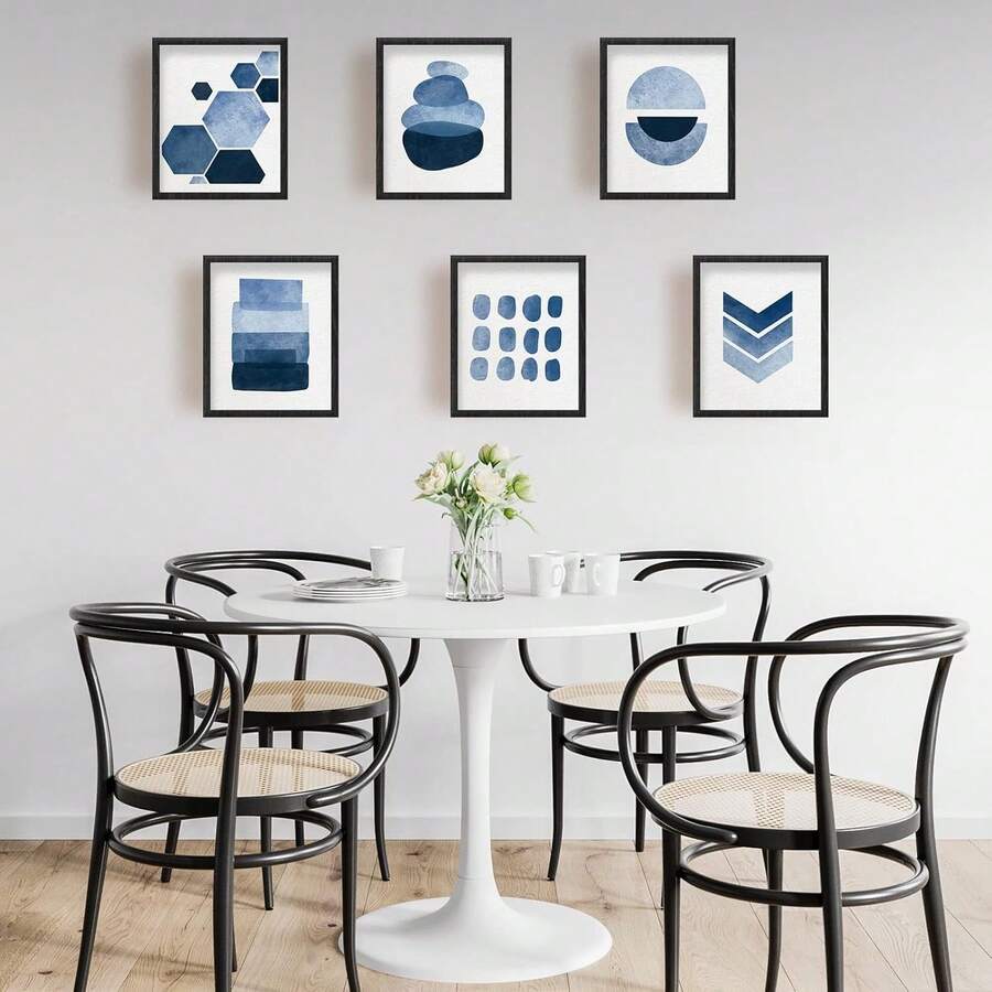 Frontal view of six black-framed blue geometric watercolor canvas prints on a white background