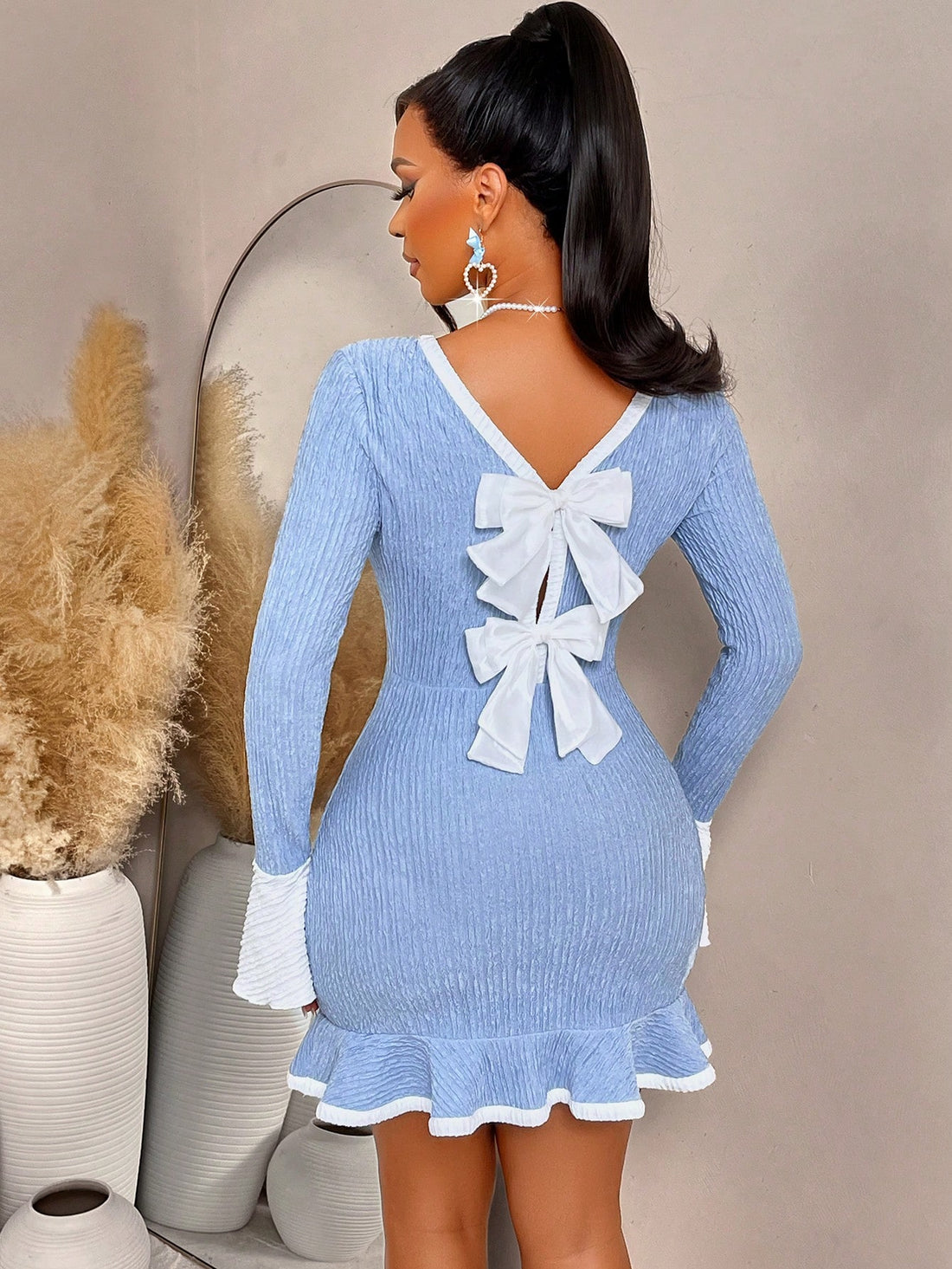 Elevate your cold-weather wardrobe with this show-stopping backless dress that proves you don't need sleeves to make a statement. The delicate bow detail adds a flirty touch, while the ruffled hem brings movement and personality to every step. Perfect for autumn and winter occasions when you want to turn heads without sacrificing style. Dress it up for nights out or down for brunch—this versatile piece is your new go-to for effortless elegance with an edge.