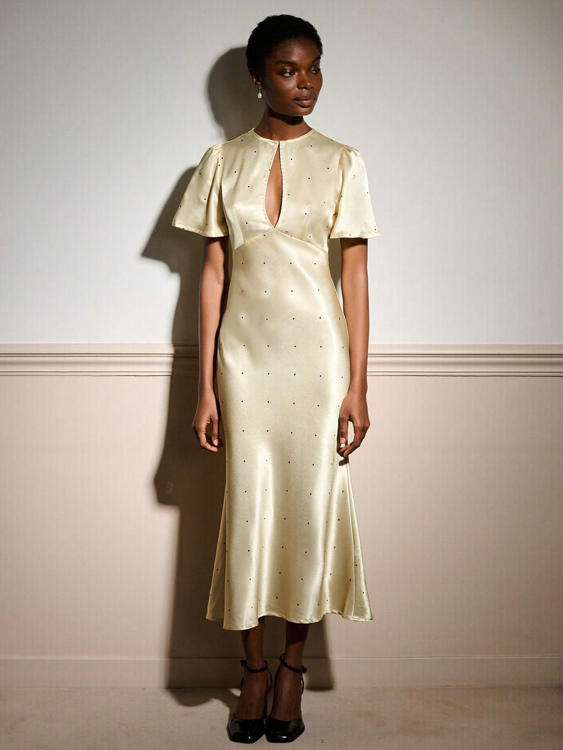 Slip into sophistication with this stunning butter yellow maxi dress that's equal parts glamorous and fun. The luxe satin fabric drapes beautifully while playful polka dots add a whimsical touch, and the cheeky keyhole detail at the neckline keeps things flirty. Whether you're heading to an elegant soirée or a romantic dinner, this dress strikes the perfect balance between timeless elegance and modern charm. Twirl, shine, and turn heads in a piece that feels as fabulous as you look.