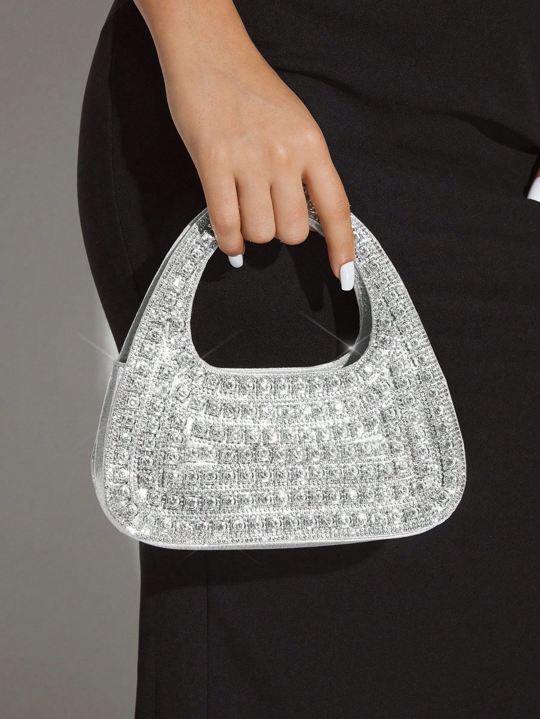 Add sparkle to your night with this Glamorous Silver Bling Evening Bag. Perfect for parties and special occasions, it’s your go-to accessory to dazzle effortlessly. Compact yet chic, it holds your essentials while shimmering with every move you make. Turn heads and steal the spotlight wherever you go!