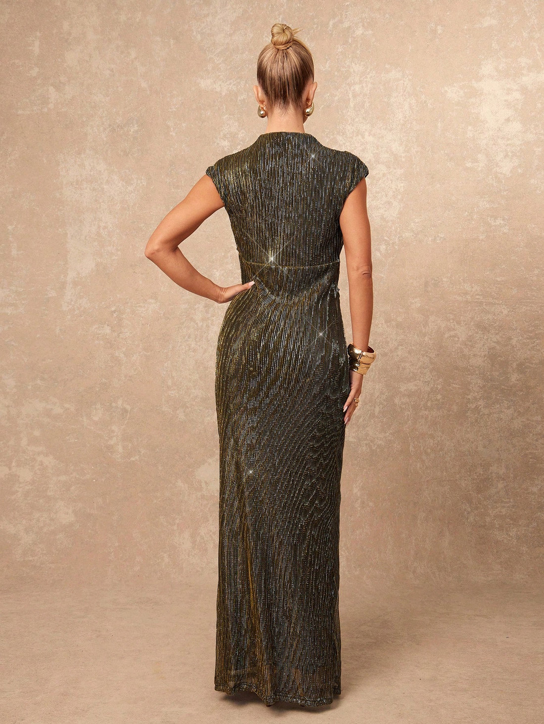 Shimmer into the spotlight in this stunning metallic lurex evening dress that's basically a disco ball with better manners. The luxurious cowl neckline drapes like you've got a stylist on speed dial, while strategic ruching smooths and flatters in all the right places. Whether you're dancing through autumn galas or turning heads at formal soirées, this dress delivers that "where did you get that?" moment every time. The metallic finish catches light beautifully, ensuring you'll be the most luminous guest in