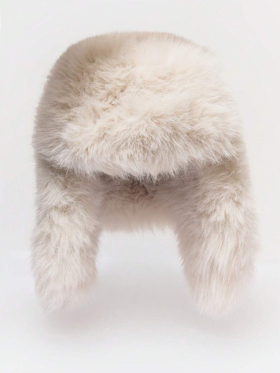 Black faux fur trapper hat with long ear flaps and dense plush texture