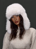 Cream white faux fur ear flap hat with rounded crown and cozy winter shape