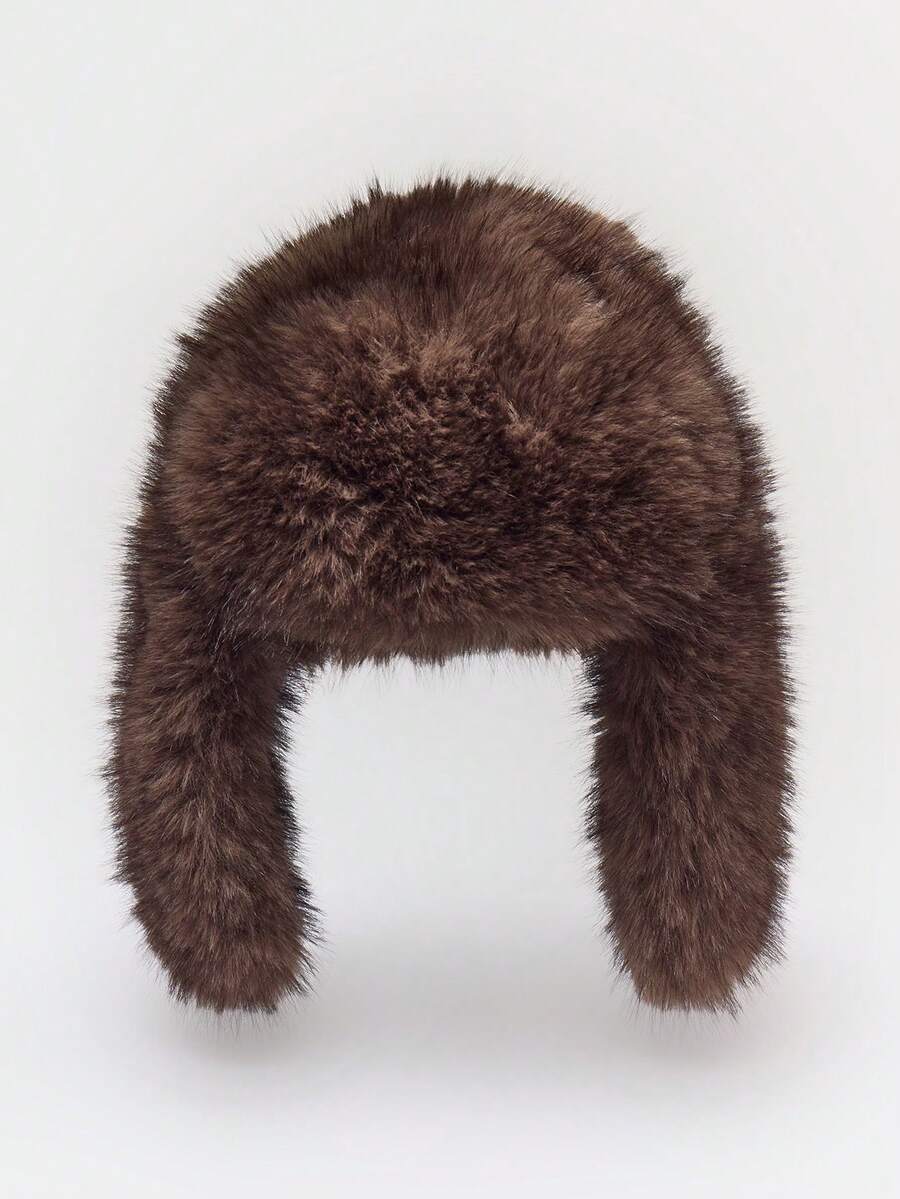 Dark brown oversized faux fur winter trapper hat with plush shaggy texture