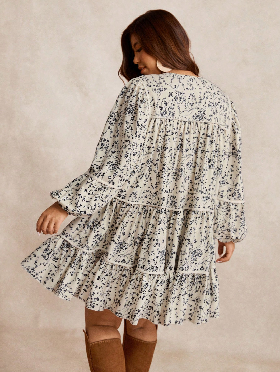 Embrace your curves in this charming black ditsy floral mini dress that's equal parts sweet and sassy. The flattering A-line silhouette skims beautifully over your figure, while playful puff sleeves add a touch of vintage-inspired fun. A tie waist cinches just right, letting you customize the fit to feel confident and fabulous. Perfect for casual outings, date nights, or whenever you want to turn heads with effortless style. This plus-size essential proves that florals aren't just for spring—they're for eve