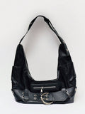 Detail view of black hobo bag showing belt buckle metal grommets and texture