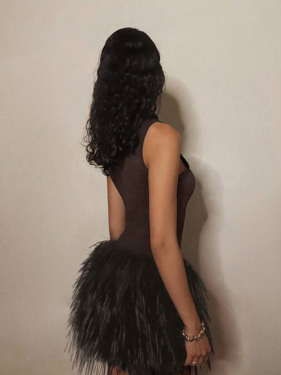 Make a statement at your next night out in this show-stopping black dress that combines edgy elegance with playful flair. The dramatic high collar frames your face beautifully while luxe feather and furry patchwork details add texture and movement that'll turn heads on the dance floor. Perfect for nightclub parties and special occasions where you want to stand out from the crowd. This dress is all about confidence, attitude, and having fun while looking absolutely fabulous.