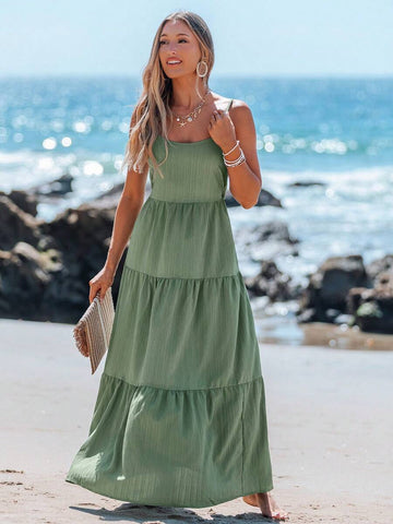 Front view of sage green tiered cami maxi dress styled at the beach