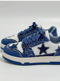 Front-side view of blue and white denim star patch sneakers with navy laces and metal eyelets for casual styling