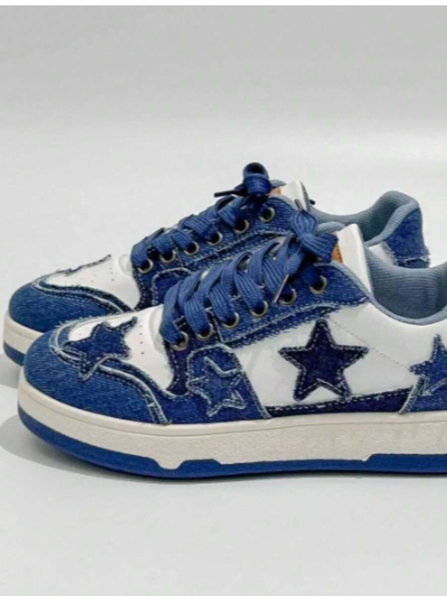Front-side view of blue and white denim star patch sneakers with navy laces and metal eyelets for casual styling