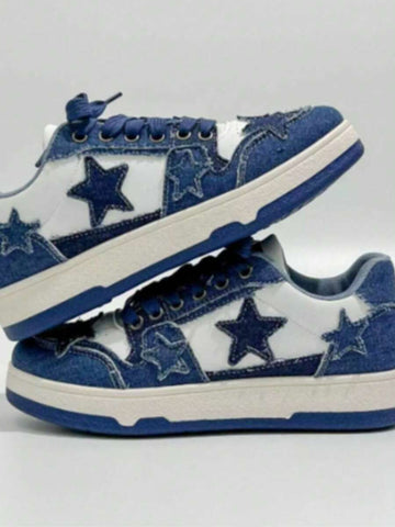 Blue and white low-top denim sneakers stacked with navy laces, star patches, cream midsole, and blue outsole