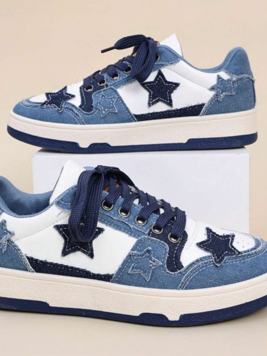 Side view of blue and white patchwork denim sneakers with frayed star appliques, navy laces, and cream platform sole