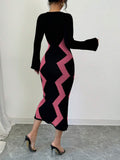 Back view of pink and black colorblock knit midi dress with covered back and fitted calf-length silhouette