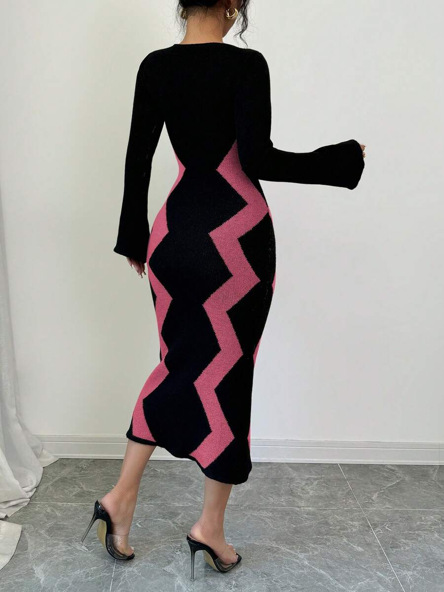 Back view of pink and black colorblock knit midi dress with covered back and fitted calf-length silhouette