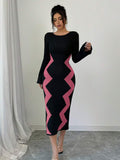 Front view of pink and black colorblock long-sleeve knit dress with slim fit and straight midi hem