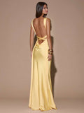 Rear angled view pale yellow satin gown with open back crossed waist ties and long skirt