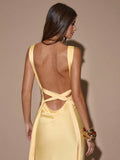 Close rear view pale yellow satin dress with low back cutout crisscross straps and side tie